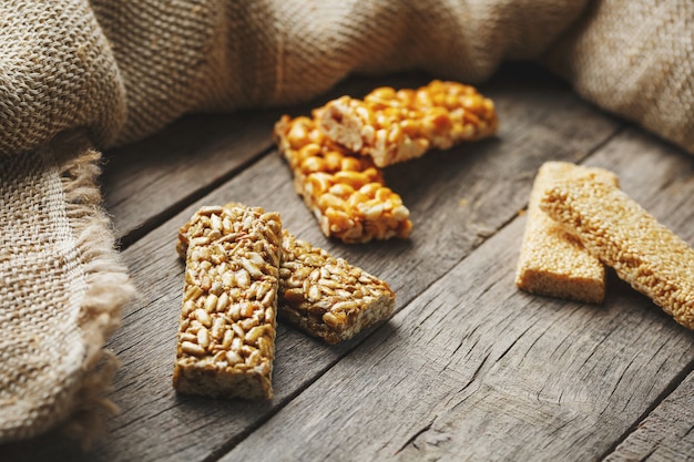 Assorted kozinaki,, with burlap fabric. Country style. Delicious sweets from the seeds of sunflower, sesame and peanuts, covered with shiny glaze.