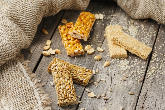 Assorted kozinaki,, with burlap fabric. Country style. Delicious sweets from the seeds of sunflower, sesame and peanuts, covered with shiny glaze.