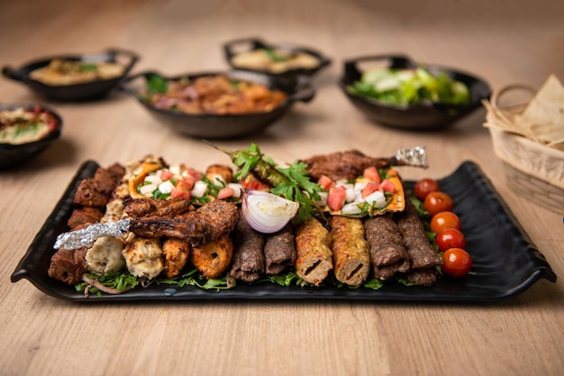 Assorted mix grills with tikka boti seekh kabab of chicken beef lamb mutton bbq platter served in dish isolated on table top view of arabian food