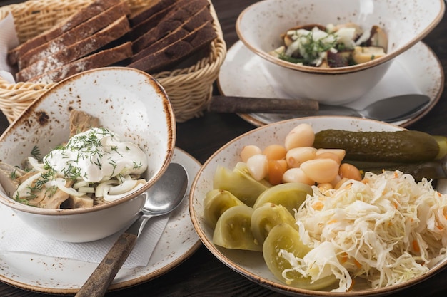 Assorted pickled vegetables in a plate and marinated mushrooms