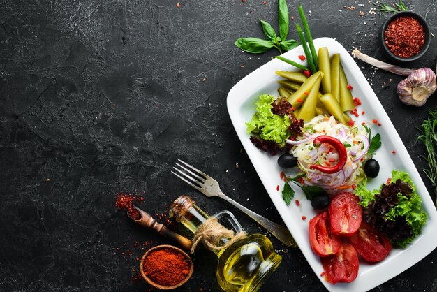 Assorted pickled vegetables on a plate. Ukrainian cuisine. Restaurant dishes. Top view. Free space for your text.