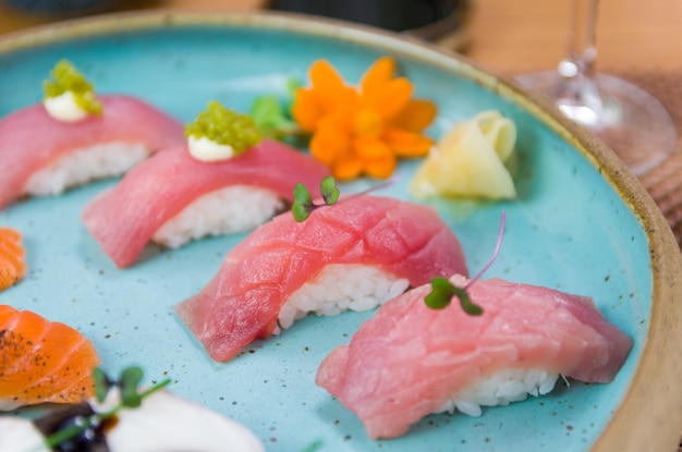 Assorted premium tuna and salmon nigiri sushi on a beautifully decorated plate