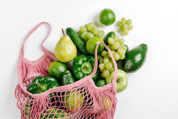 Assorted Raw Fresh Organic Green Vegetables In Pink Mesh Market Bag, Flat lay, Top View