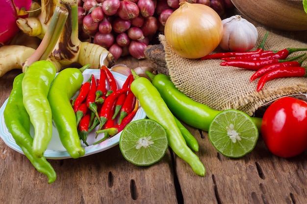 Assorted raw organic vegetables on old wooden table