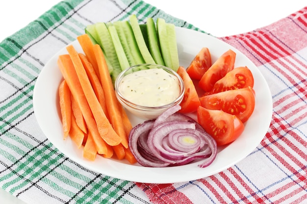 Assorted raw vegetables sticks in plate on napkin close up