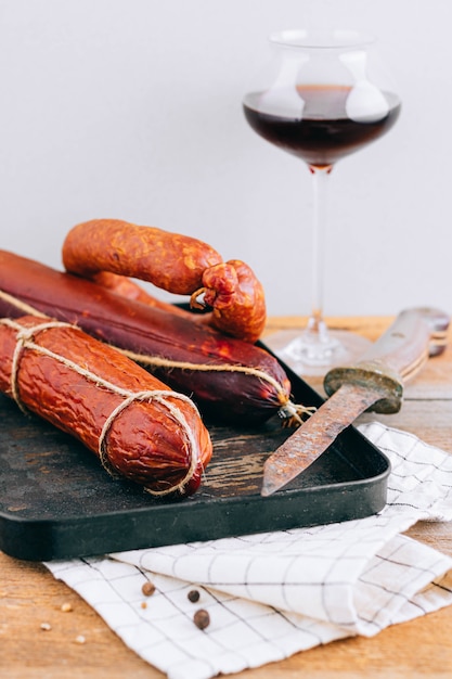 Assorted smoked sausages, appetizer to red wine on wood