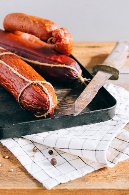 Assorted smoked sausages, appetizer on wood