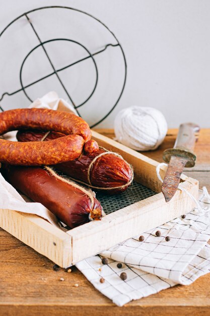 Assorted smoked sausages, appetizer on wood