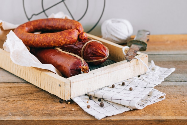 Assorted smoked sausages, appetizer on wood