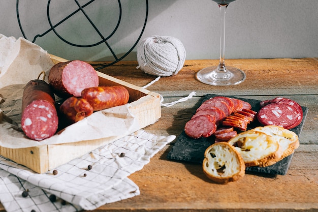 Assorted smoked sausages, appetizer on wood