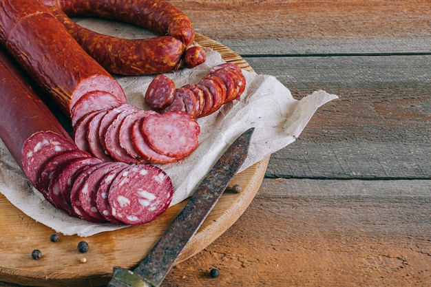 Assorted smoked sausages, appetizer on wood