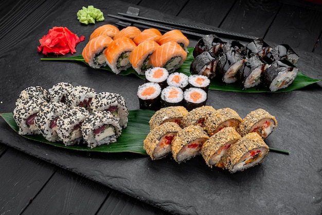 Assorted sushi nigiri and maki big set on slate A variety of Japanese sushi with tuna crab salmon eel and rolls