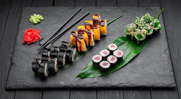 Assorted sushi nigiri and maki big set on slate A variety of Japanese sushi with tuna crab salmon eel and rolls