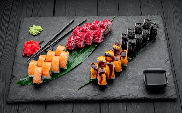 Assorted sushi nigiri and maki big set on slate A variety of Japanese sushi with tuna crab salmon eel and rolls