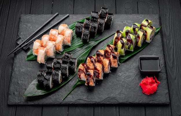 Assorted sushi nigiri and maki big set on slate A variety of Japanese sushi with tuna crab salmon eel and rolls