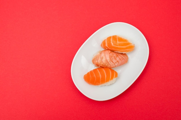 Assorted sushi on small white dish top view