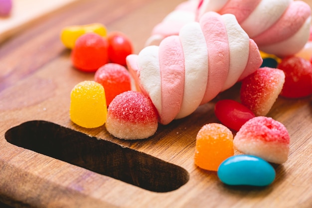 Assorted sweets on a wooden board in macro photography