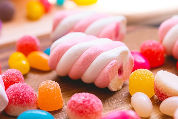 Assorted sweets on a wooden board in macro photography