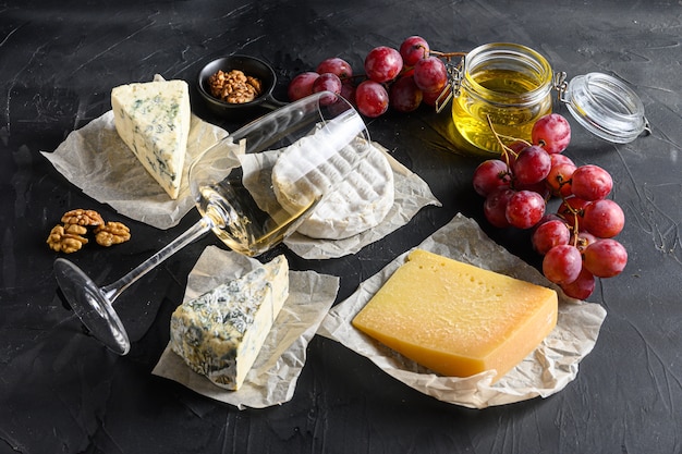 Assortment of cheeses, a glass of white sauvignon wine