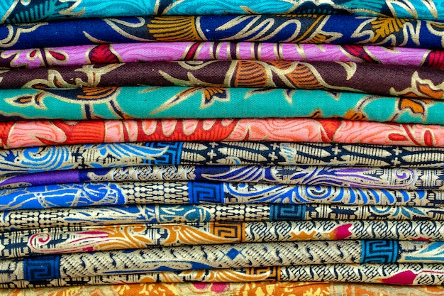 Assortment of colorful sarongs for sale in local market, Island Bali, Ubud, Indonesia. Close up