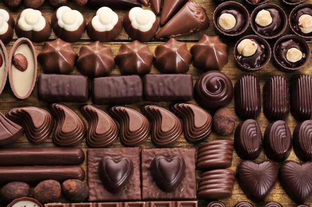 Assortment of delicious chocolate candies background, close up