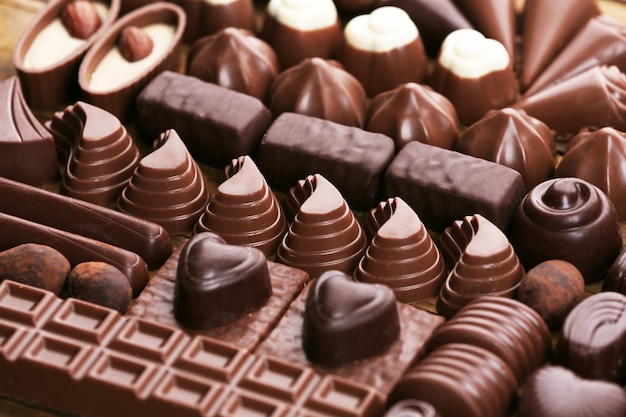 Assortment of delicious chocolate candies background, close up