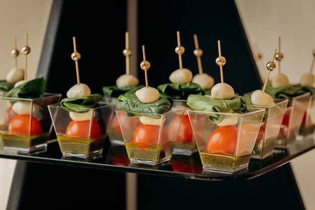 Assortment of delicious snacks on the open buffet festive table in restaurant catering plate