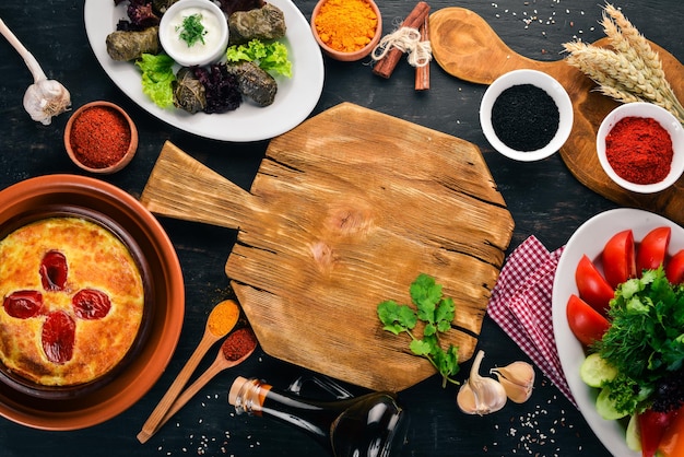 Assortment of dishes of Georgian and European cuisine On the old wooden background Free space for text Top view