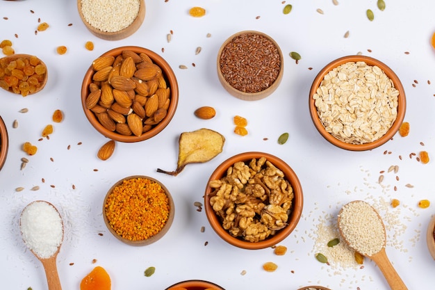 Assortment of dried fruits nuts and seeds on white background