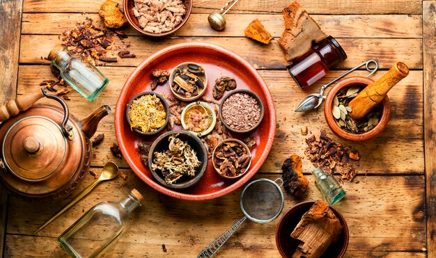 Assortment of dry healthy herbs on an old wooden table in herbal medicine. Natural medicine