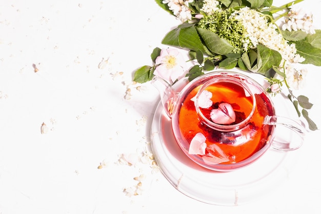 Assortment flowers tea. Fresh elderberry, rose hip, and acacia. Healthy food concept. White plaster background, top view