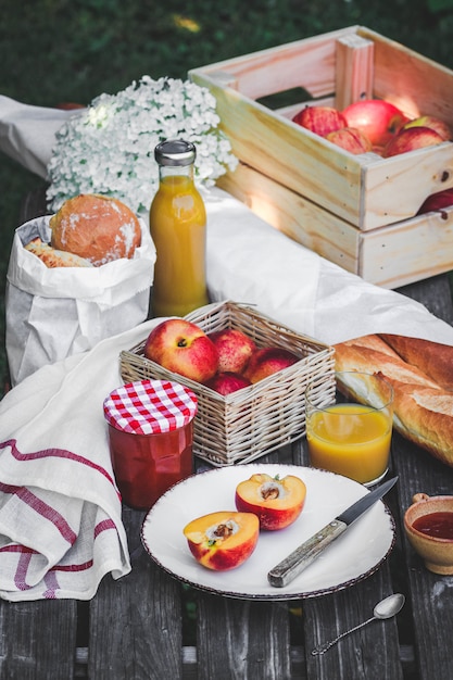 Assortment of food for picnic on wooden table.