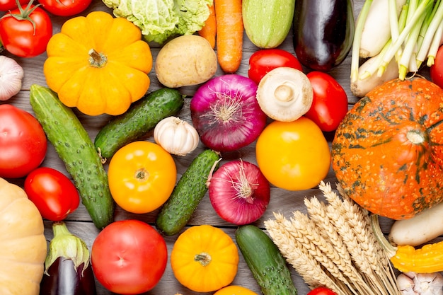 Assortment of fresh vegetables as a background. Seasonal close up farmer table with vegetables. Pumpkins, tomatoes, cabbage, carrots, onion, cucumber, melon, eggplant, potatoes and other.