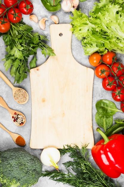 Assortment of fresh vegetables and spices on a light background