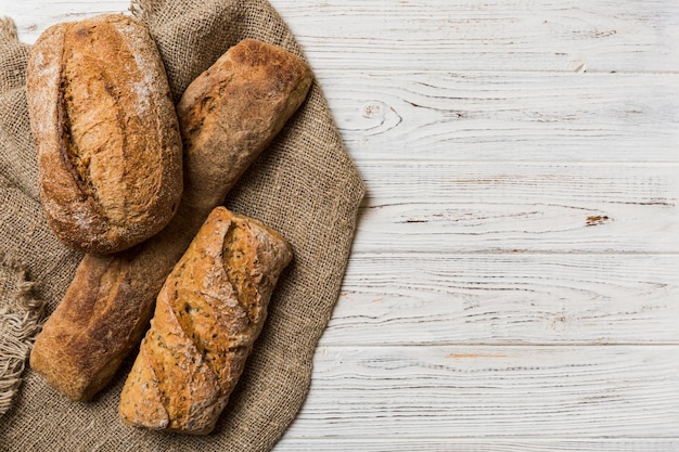 Assortment of freshly baked bread with napkin on rustic table top view Healthy unleavened bread French bread