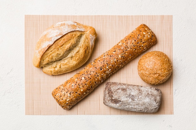 Assortment of freshly baked bread with napkin on rustic table top view Healthy unleavened bread French bread