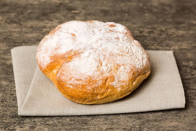 Assortment of freshly baked bread with napkin on rustic table top view Healthy unleavened bread French bread