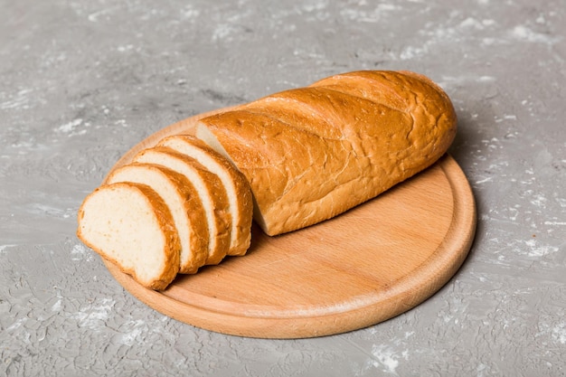 Assortment of freshly sliced baked bread with napkin on rustic table top view Healthy unleavened bread French bread slice