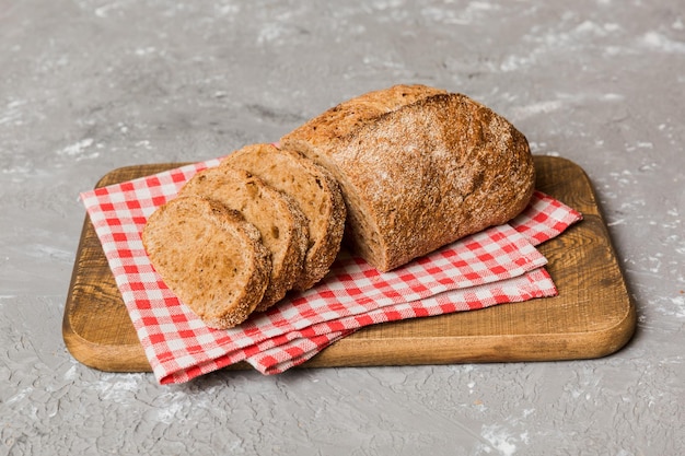 Assortment of freshly sliced baked bread with napkin on rustic table top view Healthy unleavened bread French bread slice