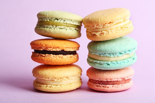 Assortment of gentle colorful macaroons on color background