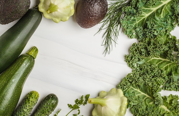 Assortment of green vegetables on white background, top view. Fruits and vegetables containing chlorophyll.