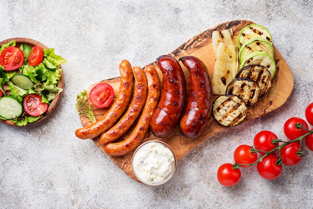 Assortment of grilled sausages and vegetables