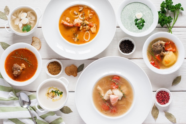 Assortment of hot soups flat lay. Top view on restaurant table with variety of warm fasting dishes