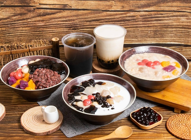 Assortment of milk tender fairy grass Brown Sugar Cut Ice Frog banging milk Peanut Soup served in bowls isolated on table side view of taiwan food