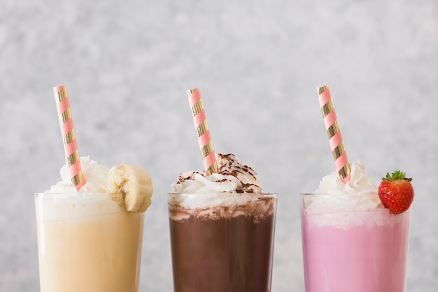 Photo assortment of milkshakes with straws