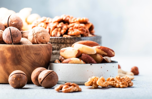 Assortment of nuts Cashews hazelnuts walnuts almonds etc Healthy Food Snacks mix on gray background copy space