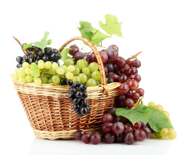 assortment of ripe sweet grapes in basket isolated on white