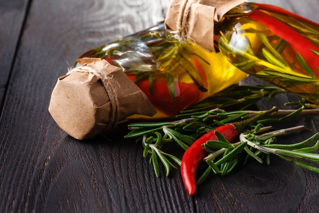 Assortment of spicy oils with herbs and spices in different bottles