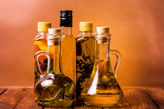 Assortment of spicy oils with herbs and spices in different bottles