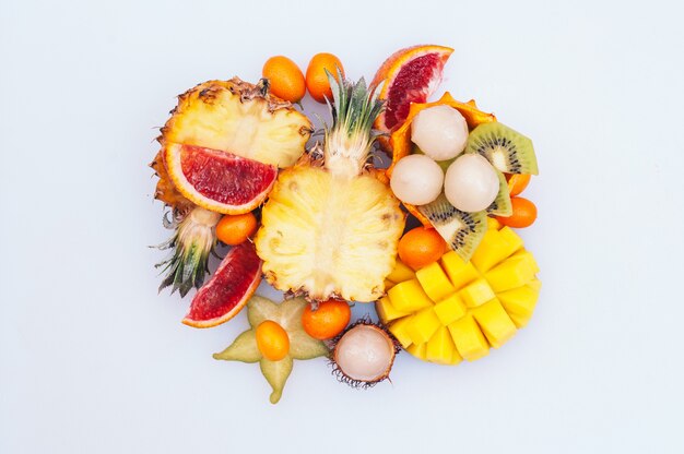 Photo assortment of tasty juicy exotic fruit on white background.